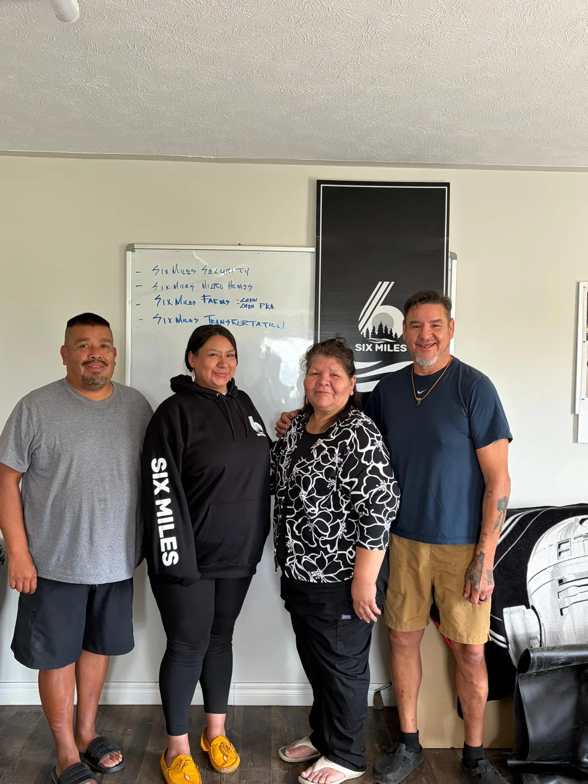 Four people, including Leslie, together in the SixMiles office